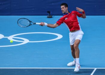 Serbia's Novak Djokovic returns a shot to Bolivia's Hugo Dellien during their Tokyo 2020 Olympic Games men's singles first round tennis match at the Ariake Tennis Park in Tokyo on July 24, 2021. (Photo by Giuseppe CACACE / AFP)