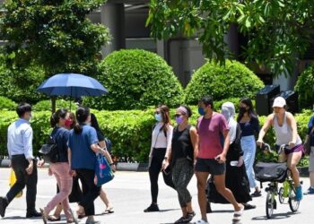 ORANG ramai berjalan di Orchard Road di Singapura. - AFP