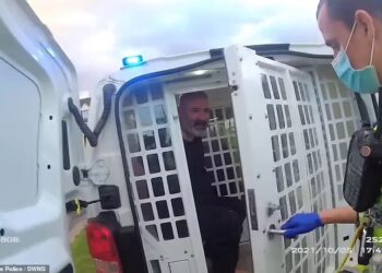 CAN Arslan dikawal ketat anggota polis ketika dibicarakan di Mahkamah Bristol Crown, Gloucestershire.-SWNS