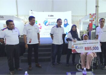NORLIZA Abdul Rahim menyampaikan sumbangan zakat kepada seorang usahawan asnaf.