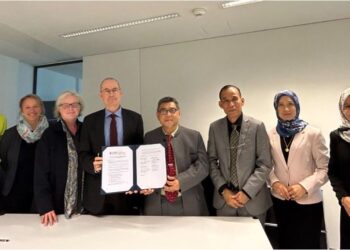 KASSIM MANSOR (empat kanan) dan Gerald Stucki (empat kiri) bergambar selepas majlis menandatangani kerjasama penyelidikan antara UMS dan Swiss Paraplegic Research di Switzerland, semalam.