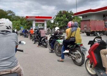PENGGUNA motosikal menyerbu stesen minyak selepas kerajaan mengumumkan kenaikan harga petrol bersubsidi. - AGENSI