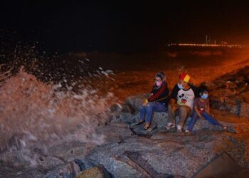 ANTARA pengunjung yang datang bersama kanak-kanak bagi menyaksikan fenomena air pasang besar di Pantai Seberang Takir di Kuala Nerus, semalam. - PUQTRA HAIRRY ROSLI