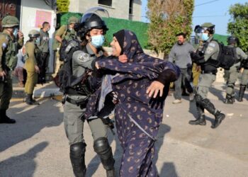 TENTERA Israel menahan wanita Palestin yang cuba menghalang kediamannya dirobohkan di Tebing Barat pada Februari lalu. - AFP