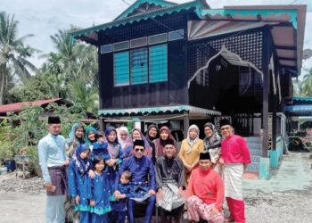 SHIDEE (depan tengah) bersama ahli keluarga dan adik-beradiknya ketika menyambut hari raya Aidilfitri di Kampung Sungai Lanchang di Bagan Datuk. - UTUSAN/AIN SAFRE BIDIN