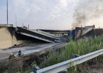KEADAAN sebahagian lebuh raya yang runtuh selepas sebuah lori tangki terbakar di bawahnya. - AFP