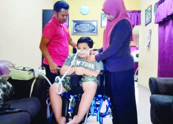 CHE Kamaruddin Che Lah dan isteri, Nur Syahirah Abdullah memasang saluran  oksigen bagi mengelak jantung Muhammad Dzulfikar Ryyan berhenti yang boleh membahayakan nyawanya ketika ditemui di Taman Ria, Sungai Petani. -UTUSAN/OTHMAN YAHAYA