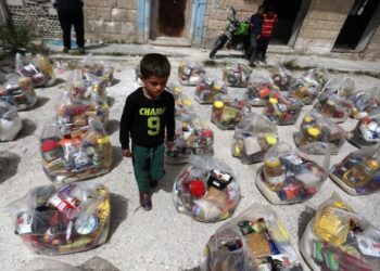 SEORANG kanak-kanak lelaki berjalan di antara bungkusan bantuan yang disumbangkan oleh
kumpulan sukarelawan di pekan al-Najieh, wilayah Idlib, Syria. - AFP