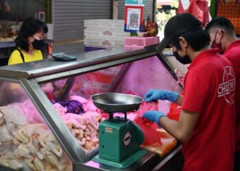 PENDUDUK membeli ayam dari sebuah gerai di pasar Bukit Merah View. - CNA