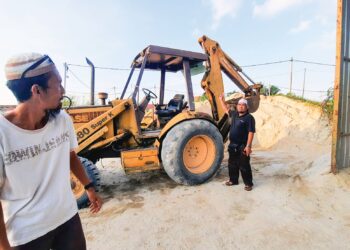BAPA saudara mangsa, Zahrin Osman (kanan) menunjukkan jengkaut dikendalikan Muhammad Sazwan Marzuki ketika disengat tebuan di Kampung Sidam Kanan, Kulim. –  MingGuan/AZAHAR HASHIM
