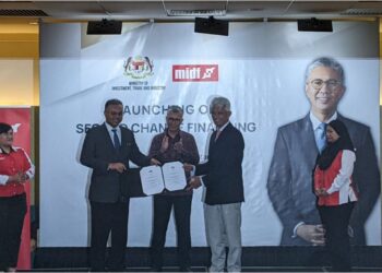 TENGKU Zafrul Tengku Abdul Aziz menyaksikan penyerahan surat pelantikan MIDF kepada Charon Wardini oleh Ketua Setiausaha MITI, Datuk Isham Ishak pada Majlis Pelancaran Skim 2CF, di Kuala Lumpur, hari ini. - UTUSAN / MOHAMAD HAFIZI MOHD SAID.