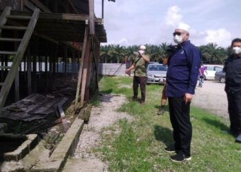 RAZMAN Zakaria (depan) melawat ladang ayam yang menjadi punca masalah lalat di Kampung Batu 2 Kampung Changkat Lobak dekat Bagan Serai hari ini. - UTUSAN/WAT KAMAL ABAS