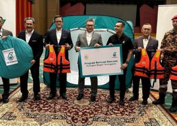 MOHAMMAD Ahmad Shazly Ramli  (tengah) menyampaikan sumbangan Petronas kepada  Tengku Farok Hussin di Kuala Terengganu, hari ini. - UTUSAN/KAMALIZA KAMARUDDIN