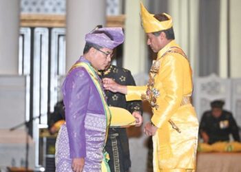 SULTAN Mizan Zainal Abidin (kanan) mengurniakan Darjah Kebesaran S.S.M.Z kepada Tengku Farok Hussin Tengku Abdul Jalil pada majlis istiadat penganugerahan darjah kebesaran dan pingat di Istana Syarqiyyah, Kuala Terengganu, semalam.