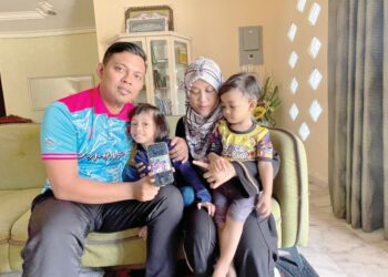 SAUFI Marwan Muhammad Hariri di samping isternya, Najla Zakaria serta dua anak mereka menunjukkan gambar keluarga di Satun, Thailand ketika ditemui di Kodiang, Kubang Pasu. - UTUSAN/JAMLIAH ABDULLAH