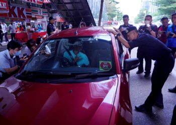 MOHD. Shuhaily Mohd. Zain menyantuni seorang pemandu kenderaan dalam program Santuni OKU Penglihatan bersama Polis Kuala Lumpur di sekitar Brickfield, semalam. – UTUSAN/FAUZI BAHARUDIN