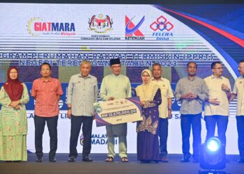 ANWAR Ibrahim (empat dari kiri) menyampaikan replika cek Program Perumahan Rakyat Termiskin (PPRT)  kepada seorang peserta pada Perasmian Sentuhan Kasih Desa Terengganu di Bandar Al Muktafi Billah Shah, Dungun, hari ini. - UTUSAN/PUQTRA HAIRRY ROSLI