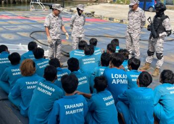 SYED Nor Adli Syed Ab. Rahman (kiri) melakukan pemeriksaan nelayan asing Vietnam di Tok Bali, Pasir Puteh, Kelantan hari ini. UTUSAN/TOREK SULONG