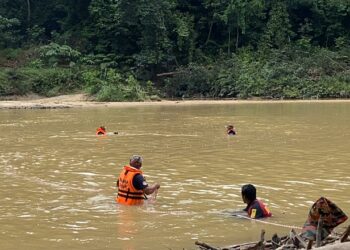 ANGGOTA SAR melakukan pencarian mangsa terakhir tragedi kepala air di Jeram Mawar, Air Putih, Kemaman, hari ini.  - UTUSAN/NIK NUR IZZATUL HAZWANI NIK ADNAN