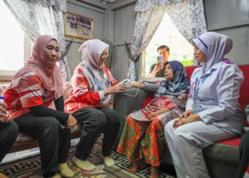 ZALIHA Mustafa (dua, kiri) melakukan pemeriksaan kesihatan seorang warga emas semasa menghadiri program Madani Fiat dan One Hour Malaysia Clean Up Peringkat Negeri Terengganu di Kuala Terengganu, hari ini. - UTUSAN/PUQTRA HAIRRY ROSLI