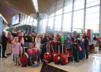 SEBAHAGIAN jemaah umrah kendalian Emraz yang berlepas ke Tanah Suci di Terminal 1, KLIA. Sepang. - UTUSAN/AMREE AHMAD