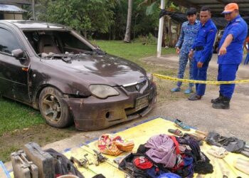 MUHAMMAD Iman Zulhakim Zamri (tengah) melihat kenderaan dan barangan peribadi keluarga mangsa tragedi kepala air baru-baru ini. – UTUSAN/NIK NUR IZZATUL HAZWANI NIK ADNAN