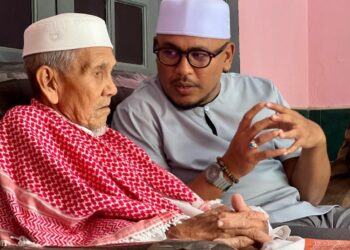 MOHD Ashraf Mustaqim Badrul Munir (kanan) beramah mesra bersama pemimpin tempatan, Salleh Lebai Yunus, 87, di Kampung Pak Chik, Jerlun, Kedah. -UTUSAN/ASYRAF MUHAMMAD
