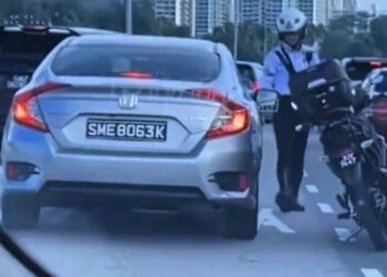 TANGKAP layar rakaman video yang tular menunjukkan seorang anggota polis cuba menahan sebuah kenderaan berpendaftaran Singapura yang melakukan kesalahan trafik di Tambak Johor.