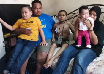 AZLAN Mohamed Yusof bersama anaknya, Iman Haiqal yang menghidap penyakit barah hati ketika ditemui di Taman Desa Aman, Batu 6, Jalan Maharaja di Teluk Intan. - UTUSAN/AIN SAFRE BIDIN