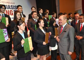 HAJIJI Noor (dua kanan) beramah mesra dengan penerima anugerah biasiswa cemerlang di Kota Kinabalu hari ini