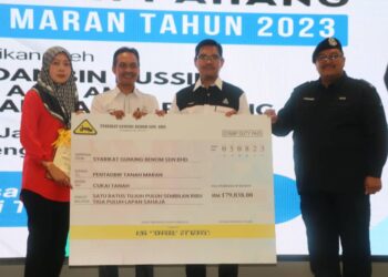 HAMDAN Hussin (dua kanan) menerima replika cukai Syarikat Gunung Benom Sdn. Bhd. di Bandar Tun Abdul Razak Jengka di Maran, Pahang. - FOTO/SALEHUDIN MAT RASAD