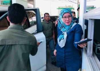 RAJA Permaisuri Agong Tunku Azizah Aminah Maimunah Iskandariah menyerahkan pasport untuk dicop sebagai prosedur kemasukan dari negara Brunei Darussalam di ICQS Sungai Tujuh, Miri tengah hari tadi.
