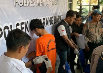 NANDO (tengah) dibawa oleh pihak berkuasa selepas menyerah diri di Balai Polis Cikarang Barat.-AGENSI
