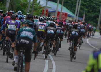 KELOMPOK besar peloton melalui Kuala Kangsar pada perlumbaan peringkat keempat dari Bukit Mertajam ke Meru Raya, Perak semalam. - UTUSAN/AMIR KHALID