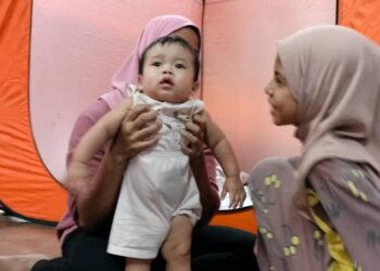 BAYI berusia tujuh bulan, Ayyyash Afi Abdul hafiz bersama ibunya antara mangsa banjir yang dipindahkan ke PPS Sekolah Kebangsaan Changkat Lobak di Bagan Serai hari ini. - UTUSAN/WAT KAMAL ABAS