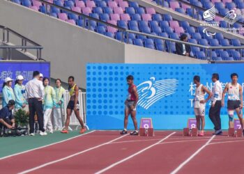 MOHAMAD Ridzuan Puzi (kiri) meninggalkan trek dengan penuh kekecewaan selepas penyertaannya dalam acara 100 meter lelaki T36 pada Sukan Para Asia 2022 dibatalkan akibat ‘false start’ di Hangzhou, China semalam. – MAJLIS PARALIMPIK MALAYSIA