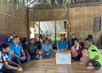 SYAHIRA Hamid (dua dari kanan) menerima kunjungan rombongan pihak Perkeso di rumahnya di Pos Pasik, Gua Musang, Kelantan, semalam.UTUSAN/IHSAN PERKESO.