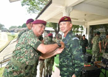 MOHAMMAD Ab. Rahman memakaikan Sayap Penerjunan Kanan Kehormat 10 Briged Para kepada Songwit Noonpackdee di Dataran Parawood, Kem Terendak, Melaka. - UTUSAN/AMRAN MULUP