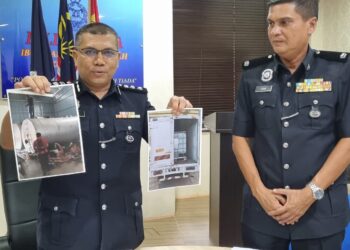 ZAIDY Che Hassan (kiri) menunjukkan gambar serbuan melibatkan kegiatan penyelewengan minyak diesel bersubsidi yang dirampas di sebuah premis di Kawasan Perindustrian MIEL, Bukit Makmur pada sidang akhbar di IPD Kuala Muda, Sungai Petani.