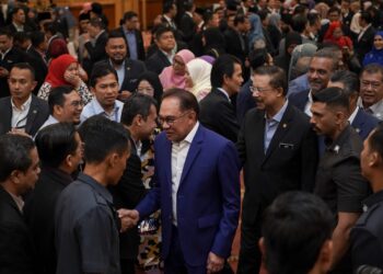 ANWAR Ibrahim ketika bermesra dengan penawat awam pada Perhimpunan Bulanan bersama warga Jabatan Perdana Menteri di Putrajaya. - UTUSAN/FAISOL MUSTAFA