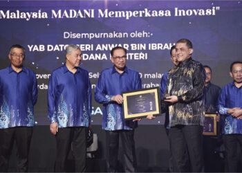 ANWAR Ibrahim menyampaikan anugerah kepada Syed Hamadah Syed Othman disaksikan Timbalan Perdana Menteri, Datuk Seri Dr. Ahmad Zahid Hamidi di Putrajaya, baru-baru ini.