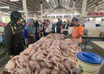 NORAZAH Jaapar (dua dari kiri) memantau harga ayam di Pasar Besar Sena, Kangar, Perlis selepas penamatan subsidi oleh kerajaan bermula hari ini. -UTUSAN/ASYRAF MUHAMMAD