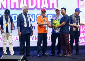 MOHAMAD Sabu (tengah) menyampaikan hadiah kepada pemenang pertandingan Badang Challenge, Rostam Mat Rapandi, 43, pada Penutup HPPNK 2023 di Bulatan Sultan Azlan Shah di  Ipoh hari ini. - UTUSAN/MUHAMAD NAZREEN SYAH MUSTHAFA