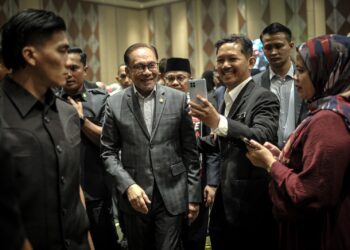ANWAR Ibrahim bermesra dengan peserta program Kolokium Madani Perkhidmatan Awam di Putrajaya. - UTUSAN/FAIZ ALIF ZUBIR