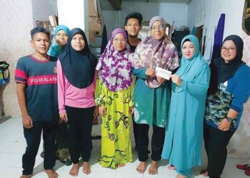 NIK Izzati Nik Aziz (tiga dari kanan) menerima sumbangan zakat daripada Che Norhayati di rumahnya 
di Kampung Sungai Pas, Kuala Krai, Kelantan. – UTUSAN/ROSMIZAN RESDI