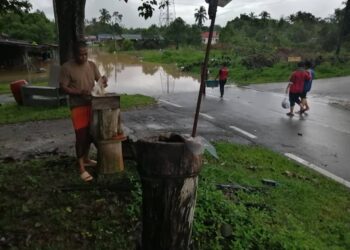 YAHYA Yasin melihat sarang lebah kelulut diusahakannya yang semakin hampir dinaiki air akibat banjir di Kampung Paya Besar, Hulu Terengganu, hari ini. - UTUSAN/NOOR HAYATI MAMAT