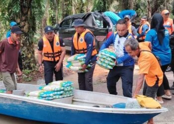 BEKALAN beras dan air mineral dihantar menggunakan bot ke Kampung Orang Asli Sungai Peroh di Kahang, Kluang.