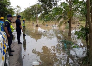 ANGGOTA polis memantau keadaan banjir serta kediaman penduduk di Kampung Seberang Batu Badak, Segamat yang terjejas akibat banjir demi menjaga keselamatan nyawa dan harta benda masyarakat.