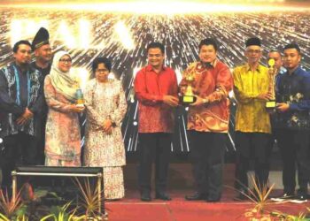 ZAHARI Sarip (tengah) menunjukkan  piala Anugerah Perdana Persijilan Amalan Pertanian Terbaik Anjasmara Ta'zim sempena Majlis Apresiasi Pensijilan Amalan Pertanian Baik di Hotel Renaissance, Johor Bahru di sini. UTUSAN/RAJA JAAFAR ALI