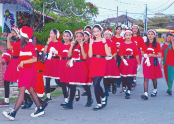 ANAK-anak penduduk setempat memeriahkan lagi suasana dengan melakukan perarakan dan persembahan dengan memakai baju berwarna merah dan putih ketika tinjauan di Perkampungan Portugis, Melaka. 
– UTUSAN/SYAFEEQ AHMAD
